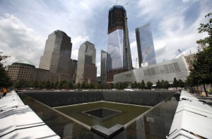 A general view shows the south pool waterfall and the under construction One World Trade Center tower in New York