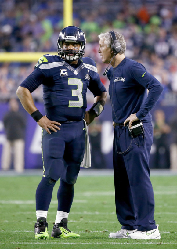 El mariscal de los Seahawks de Seattle Russell Wilson (i) conversa con el entrenador Pete Carroll (d).