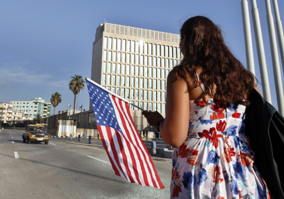 Una mujer camina con una bandera de EE.UU. frente a la embajada de ese pa&iacute;s en La Habana, Cuba. 