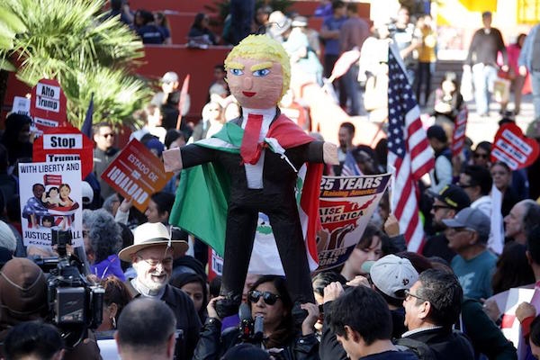 Un manifestante lleva una Donald Trump piñata mientras se une a más de mil manifestantes en una marcha por el Día Internacional de los Migrantes a través del centro de Los Ángeles, California