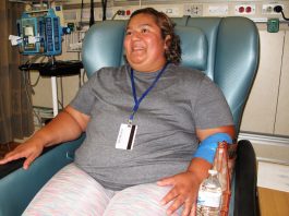 Brenda Aldana, de 34 años, durante su cita mensual en el Clinical Center de los NIH, en junio, en la que recibe medicación intravenosa para tratar su artritis. Aldana fue diagnosticada con lupus hace nueve años y participa de un estudio médico.(Paula Andalo/KHN)