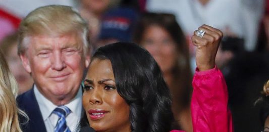 Fotografía de archivo que muestra al entonces candidato a la presidencia estadounidense, Donald Trump (i), mientras escucha el discurso de su principal asesora afroamericana, Omarosa Manigault Newman (d), durante un acto de campaña en Charlotte, Carolina del Norte (Estados Unidos), el 14 de octubre del 2016.