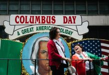 Dos mujeres sonríen desde una carroza durante el desfile anual del Día de Colón el lunes 8 de octubre de 2018, en Nueva York