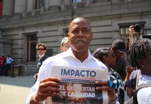 ERIC ADAMS HOLDING IMPACTO