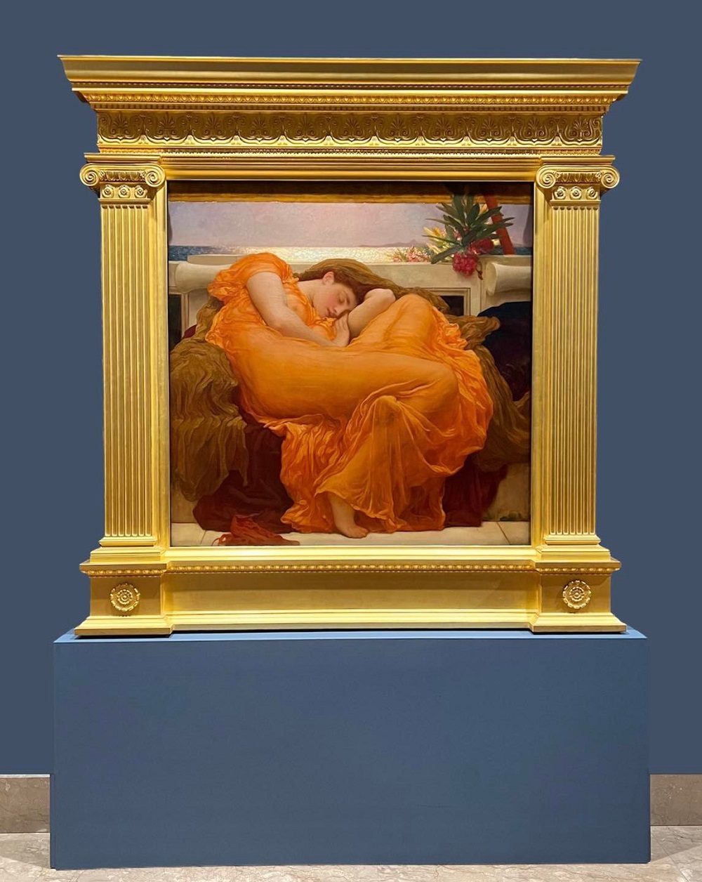 La famosa obra Flaming June, expuesta en el Met, muestra envuelta en cortinas líquidas y radiantes a una hermosa mujer dormida, revelando la forma de su cuerpo desnudo, sentado de perfil. El dinamismo de su cuerpo, que parece girar sobre sí mismo, produce la sensación de movimiento en un bucle continuo. (Foto Tomada del Facebook del Museo de Arte de Ponce)