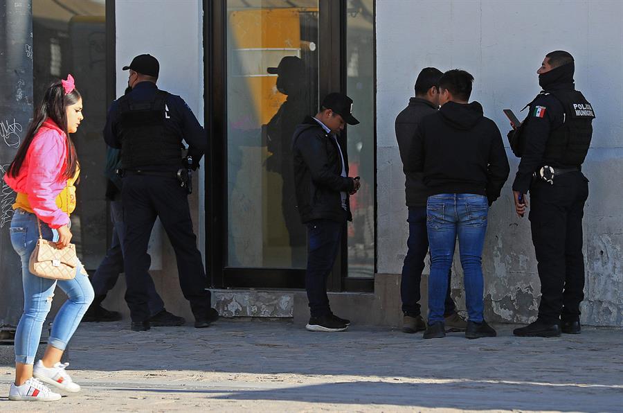 Personal de la policía municipal, realiza operativos de inspección a un grupo de migrantes hoy, en Ciudad Juárez