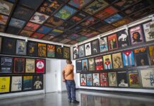 Un hombre mira una exposición de carteles permanentes en el Instituto Cubano del Arte e Industria Cinematográficos