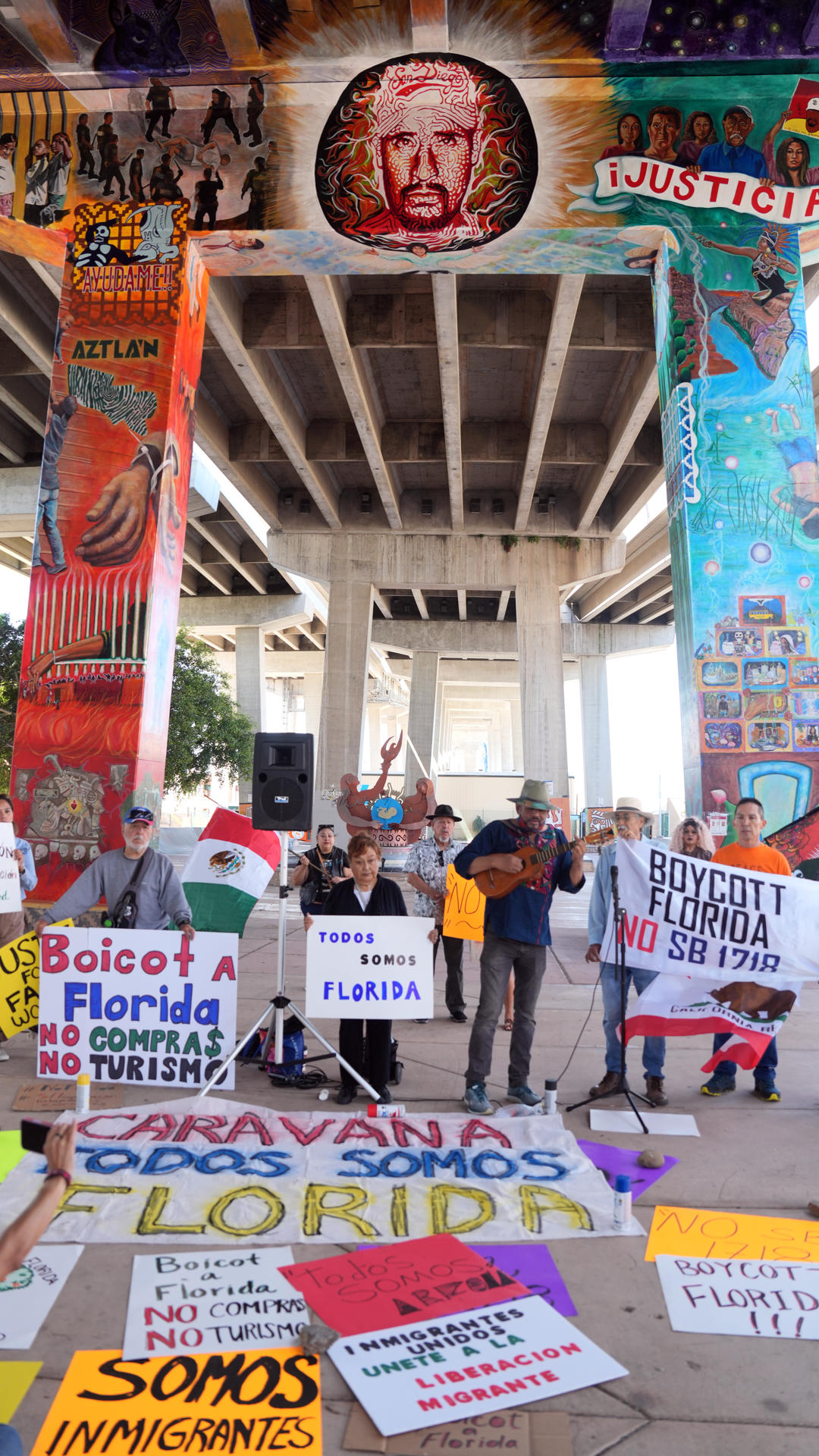 El compositor Eduardo Parra (c), quien hizo adaptaciones a algunas canciones para estrenarlas en el recorrido hacia Florida, toca la guitarra frente a un grupo de activistas