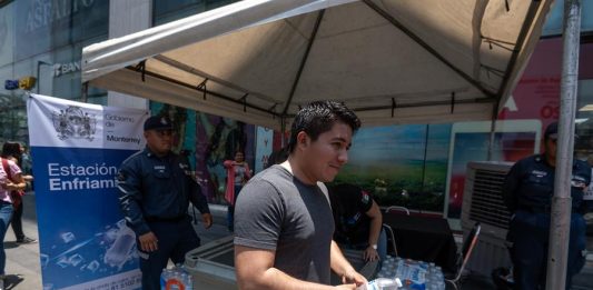 Personas reciben botellas de agua entregada por integrantes de Protección Civil debido a las altas temperaturas (2)