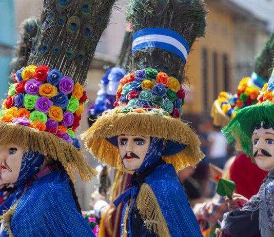 Varios hombres participan del tradicional del baile del toro huaco hoy, durante la tradicional procesión del Tope de los Santos en el municipio de Diriamba, Nicaragua.