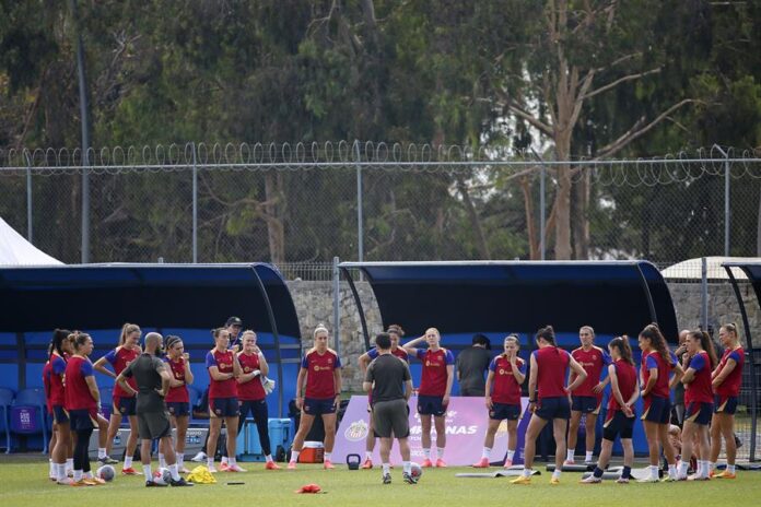 El entrenador del equipo Barcelona femenil, Jonatan Giráldez (c) habla con las jugadoras durante un entrenamiento