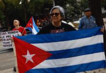 Una persona sostiene una bandera de Cuba durante una manifestación este sábado, frente a la Embajada de Estados Unidos en Ciudad de México