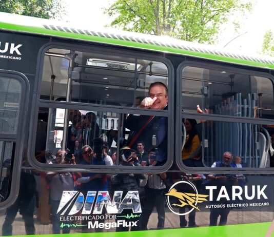 El secretario de Economía, Marcelo Ebrard, saluda desde un autobus