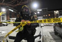 People protest after fatal shooting of man by federal agents