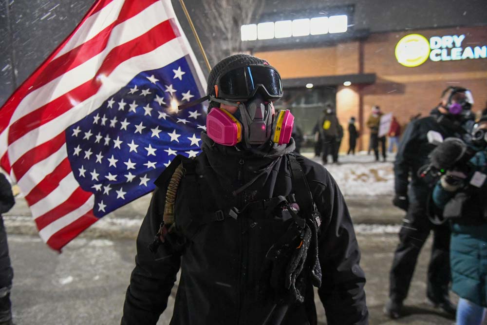 People protest after fatal shooting of man by federal agents