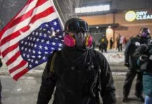 People protest after fatal shooting of man by federal agents