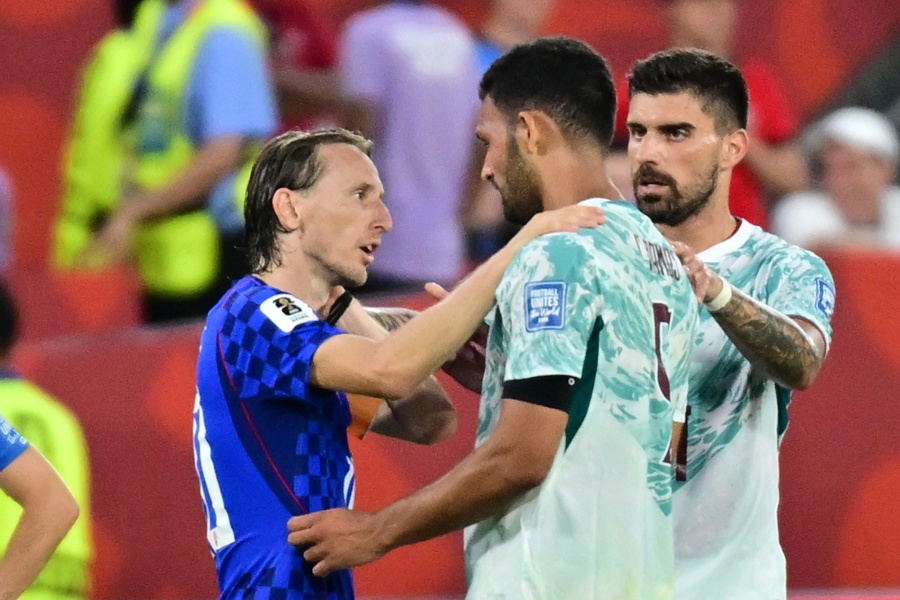 Goncalo Ramos of Portugal (R) talks with Luka Modric 