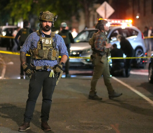 Agentes del FBI custodian un vehículo luego de un tiroteo que dejó un hombre herido