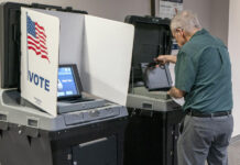 integrante de las mesas electorales alistando equipos de tecnología para las votaciones en Fairfax